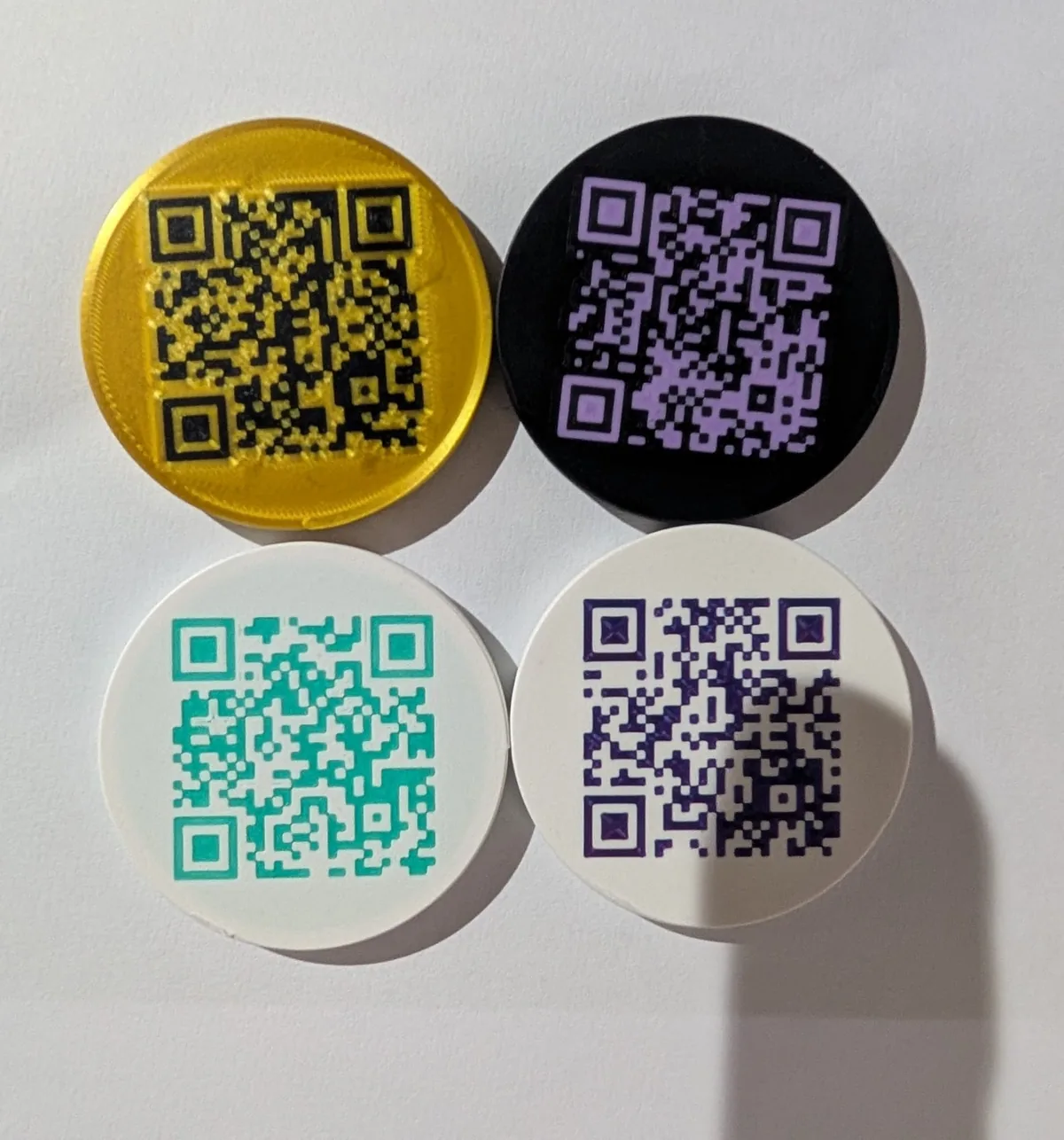 Back sides of custom printed tokens with QR codes